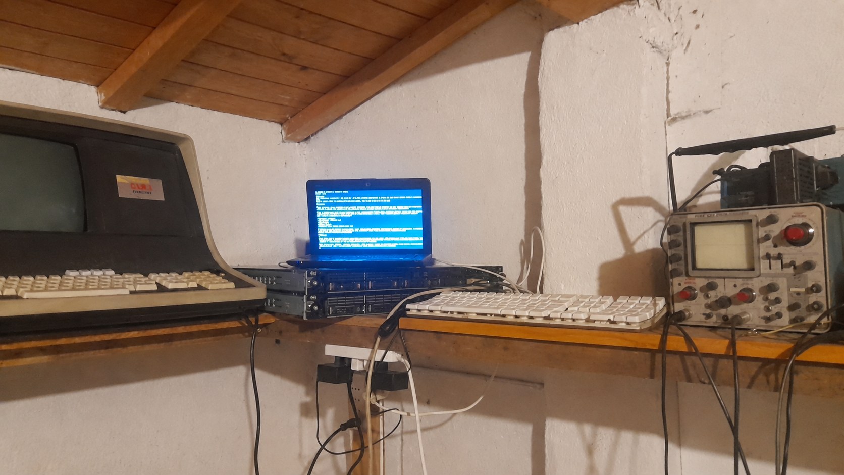 Il banco del Cluster Malvagio con terminale storico, server, tastiera e oscilloscopio